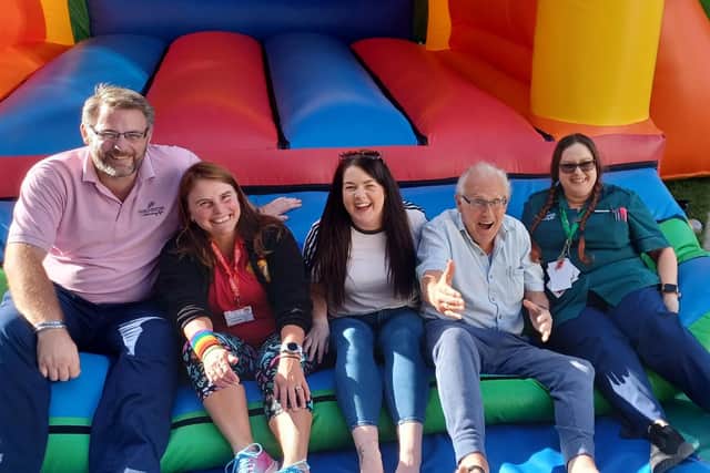 Residents at an Eastbourne care home had quite a surprise on Friday afternoon when they saw a multi-coloured bouncy castle in their back garden. Picture: Mortain Place