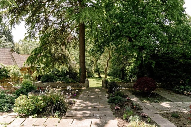 To the rear of Wings Place is a large flagstone terrace overlooking the beautiful gardens