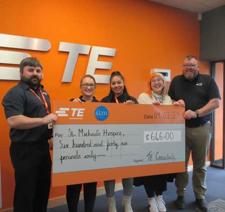 Thomas Woolven, Jenny Dobinson, Georgiana Mitroi and Tom Reid, Plant Manager, present the cheque to Sophie Bailey, St. Michael's Hospice.