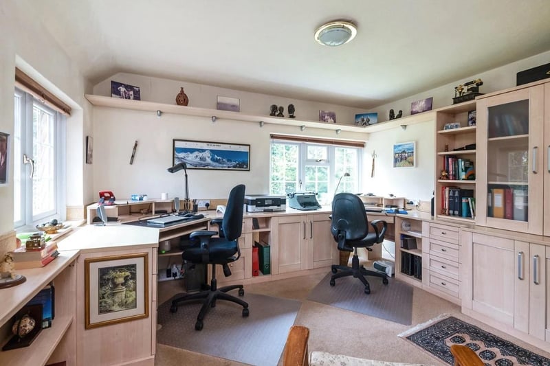 A double aspect bedroom is currently used as a home office