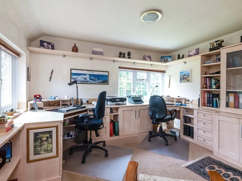 A double aspect bedroom is currently used as a home office