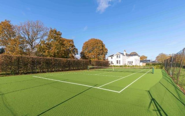 The well kept tennis court is surrounded is neatly surrounded by laurel hedging as well as a charming vegetable garden immediately adjacent to the rear of the house.