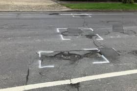 St Leonard's Road in Horsham is strewn with deep potholes near its junction with Comptons Lane
