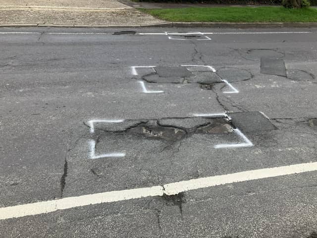 St Leonard's Road in Horsham is strewn with deep potholes near its junction with Comptons Lane