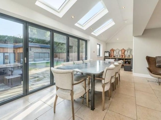 The family dining area has views across the patio to the studio/sauna