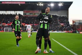 Pervis Estupinan celebrates scoring Brighton's first goal at Stoke with teammate Joao Pedro | Photo by Gareth Copley/Getty Images