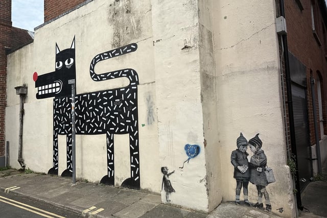 Three pieces of street art in East Pallant, Chichester: The dog is by Joachim, a street artist from Belgium, but the two smaller pieces are by another artist: JPS, from Weston Super-Mare, who cites Banksy as among his inspirations.