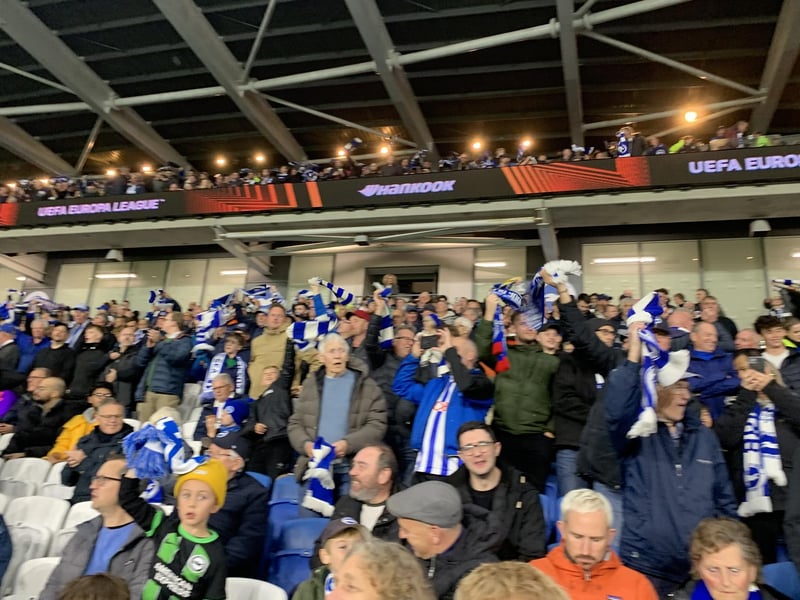 Fans waving their flags in appreciation for their team as they come out of the tunnel.