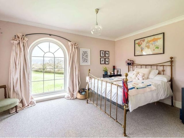 There is a further bedroom with its own picture window and well-appointed en suite bathroom. The left hand staircase leads to the original portion of the house which provides a guest suite - comprising a bedroom, dressing area and en suite shower room - and three further double bedrooms, one currently used as a gym