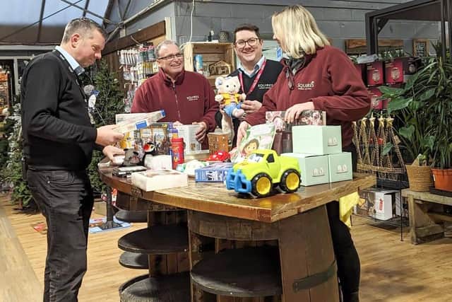 Above from left: Chris Darntell, Squire’s Manager, with colleagues, preparing the Pop-up Shop