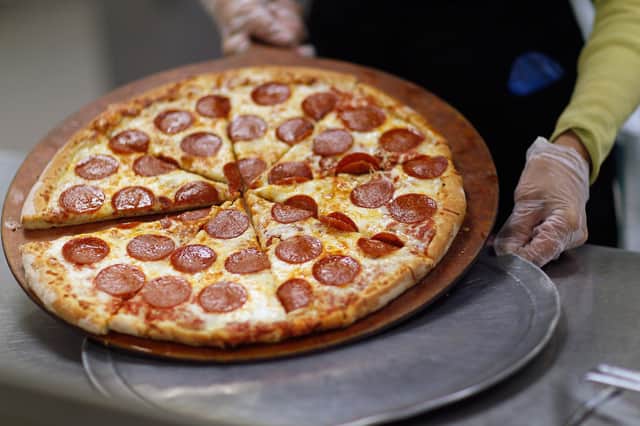 Whether you want to eat in, take away or have it delivered, there is a wide variety of great places serving pizza in the Chichester area.  (Photo by Joe Raedle/Getty Images)