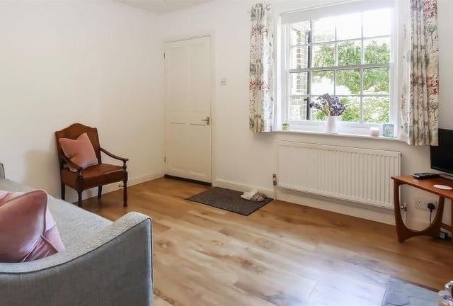 The entrance hall leads into the cosy living room