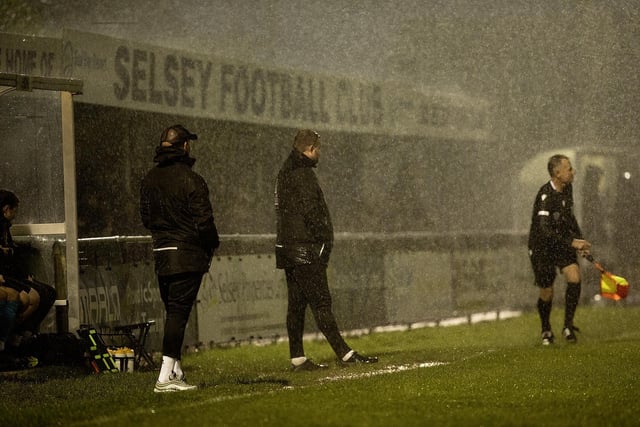 Very heavy rain during the first half of Selsey v Roffey, Manager Daren Pearce (left) and Assistant get a soaking.:Selsey v Roffey action in SCFL Division 1