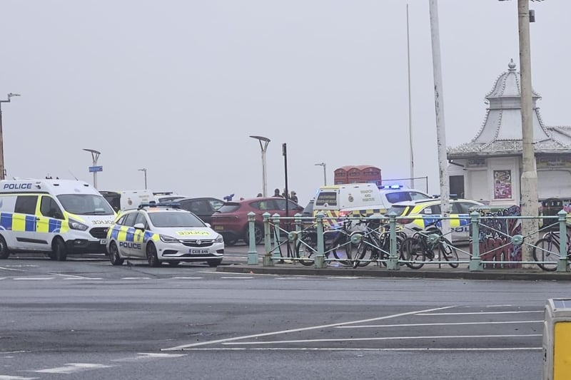Multiple police vehicles and the coastguard are on the scene