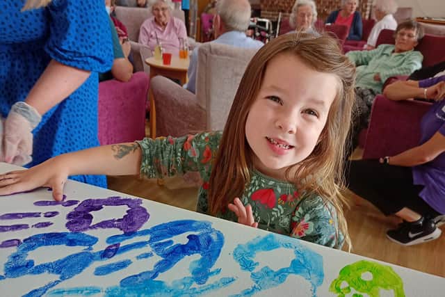 One young visitor taking part in the community art project