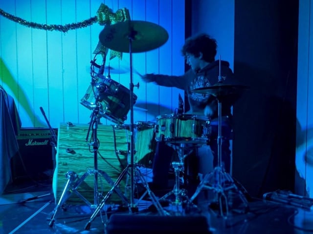 On the drums.