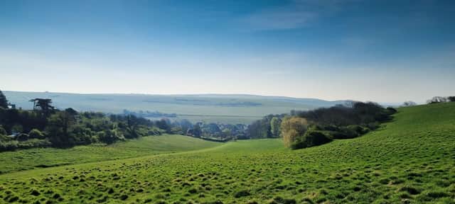 The South Downs pictured from East Dean, looking towards the Seven Sisters and the sea. This photograph was taken by Mike Tedford