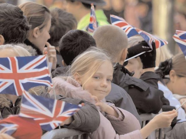 A youngster is all smiles as the Queen visits Crawley