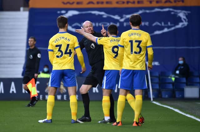Joel Veltman, Neal Maupay, and Pascal Gross of Brighton and Hove Albion confront Referee Lee Mason. (Photo by Rui Vieira - Pool/Getty Images)