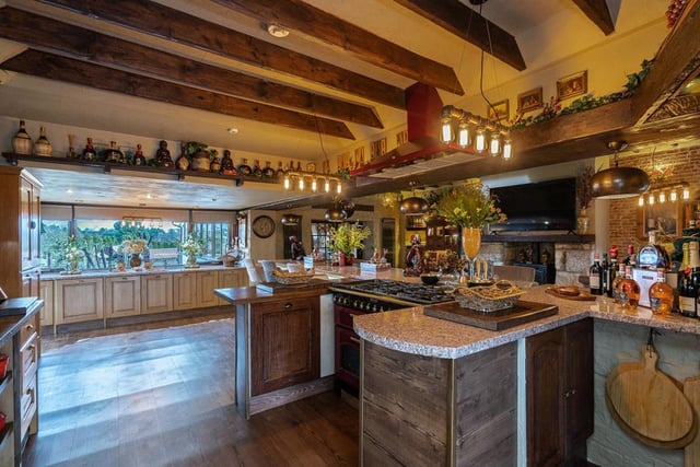 The kitchen area has everything imaginable and more including granite worktops, exposed beams, an AGA, pizza oven, breakfast bar, wine fridge and mood lighting.