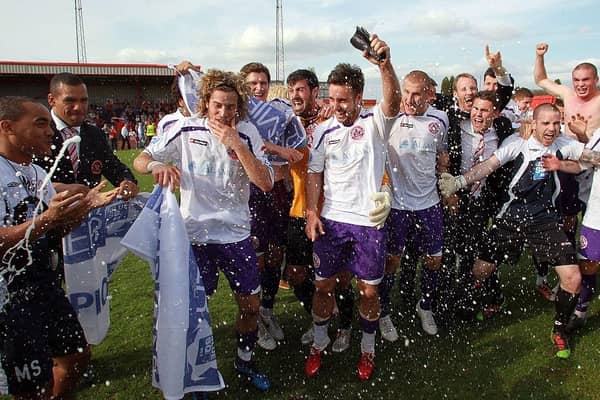 Crawley Town celebrate promotion to the Football League after victory over Tamworth at The Lamb Ground on April 9, 2011.