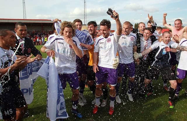 Crawley Town celebrate promotion to the Football League after victory over Tamworth at The Lamb Ground on April 9, 2011.