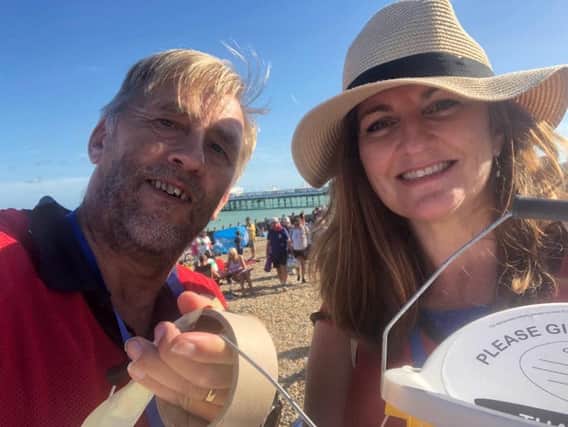 Caroline Ansell helps a volunteer at Airbourne collecting donations to help towards the costs of the show and for charity