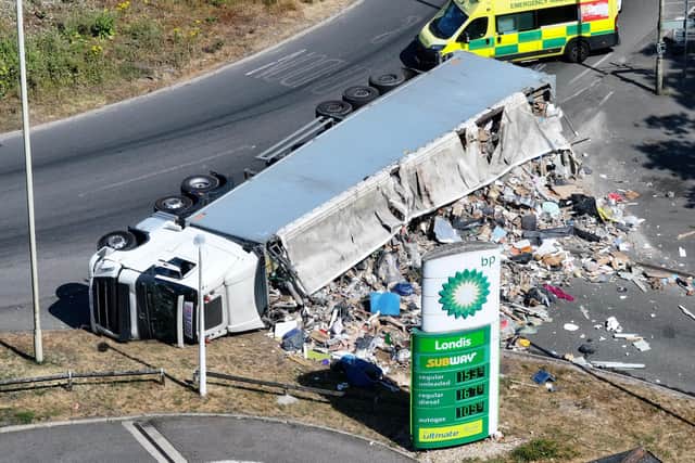An articulated lorry came to rest on its side on the A23 London Road at the Mill Road roundabout, beside a BP petrol station. Photo: Eddie Mitchell