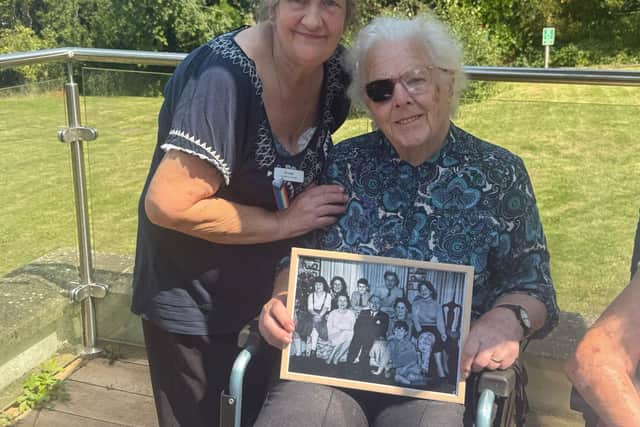 Barbara is all smiles as activities coordinator Shelagh presents her with a framed photograph from her days as a nanny to Lord and Lady Pakenham and their eight children.