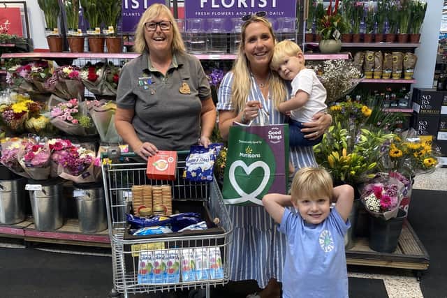 Louisa Kingham with her sons Theo and Jasper, collecting a trolley full of donations from Alison Whitburn at Morrisons in Littlehampton