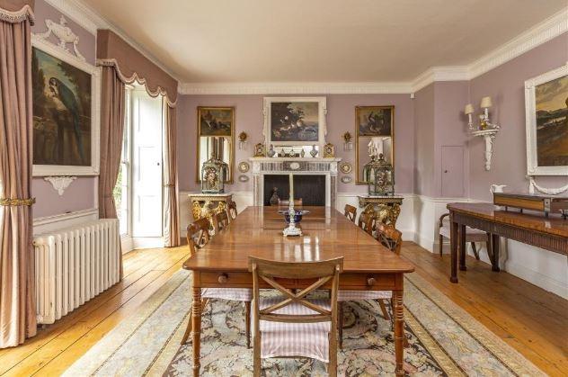 The formal dining room benefits from tall sash windows, with interior shutters. The dining room has central heating and a marble fireplace with cast iron firebasket; there is a hatch which opens to the kitchen.