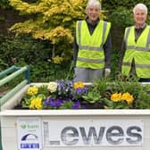 Lewes Pots and Plants volunteers Sarah Boughton and Mary Sautter with the station's luggage trolley
