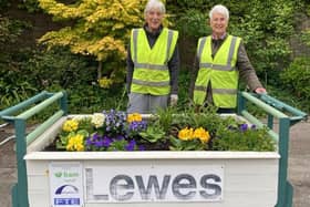 Lewes Pots and Plants volunteers Sarah Boughton and Mary Sautter with the station's luggage trolley