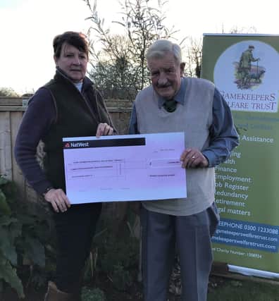 BASC South East director Michelle Nudds presenting a cheque to Walter Cole, one of the founding trustees of the Gamekeepers Welfare Trust.