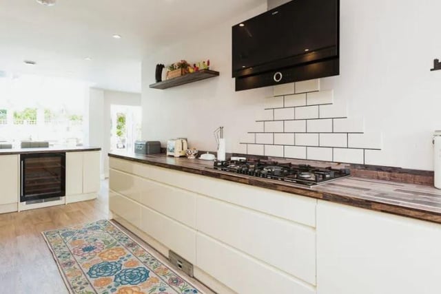 The kitchen has integrated appliances including a Neff 5 ring hob with Bosch extractor fan, Bosch dishwasher, 2 Neff hide and slide oven, washing machine and tumble dryer, wine fridge for both white and red wine.