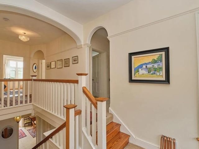 The original wide staircase leads upstairs with its five double bedrooms, a family bathroom with separate walk-in shower, a bathroom to the master bedroom, and two further separate wc's and a walk-in airing/ boiler cupboard.