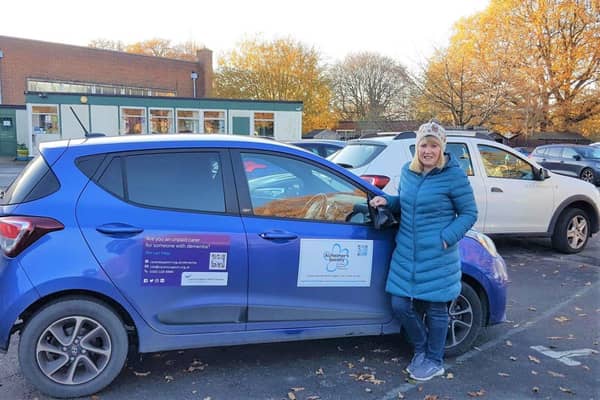 A volunteer's car displaying information and QR code for Alzheimer's Society and Carer's Support West Sussex