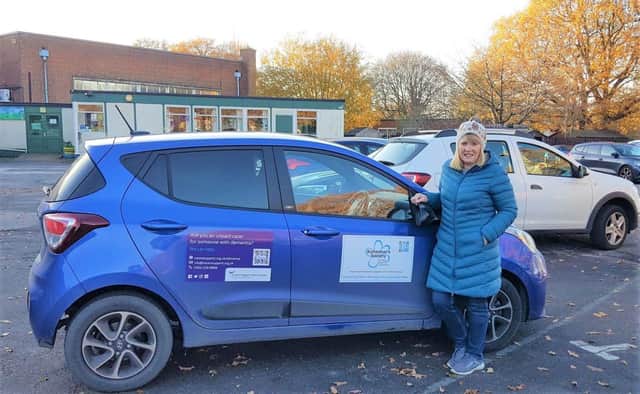 A volunteer's car displaying information and QR code for Alzheimer's Society and Carer's Support West Sussex