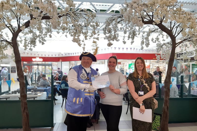 Worthing Dementia Action Alliance presenting a certificate to The Guildbourne Cafe, which gave up its seating area for the afternoon tea