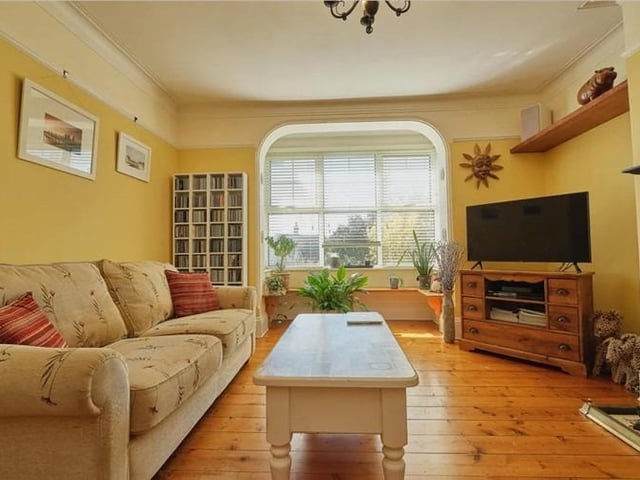 The living room is bright and airy, boasting wooden flooring, gas fire with stunning original cast iron surround, original picture rails and bay window.