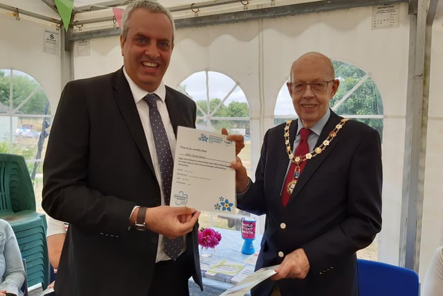 Arundel mayor Tony Hunt presents Stephen Sampson, head of private client, with the Dementia Friendly 2022 certificate for Monan Gozzett solicitors