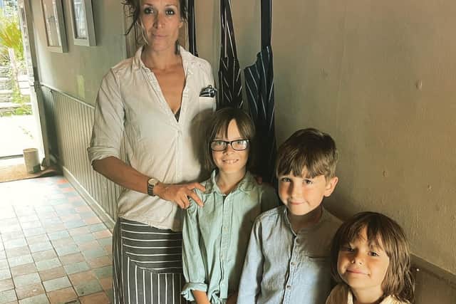 Sammie King with her children whose garden play equipment was submerged in raw sewage during Pulborough floods
