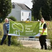 Councillor Chris Mullins and Patch Worker Steven Weston hold the Green Flag Award (Photo by Jon Rigby)