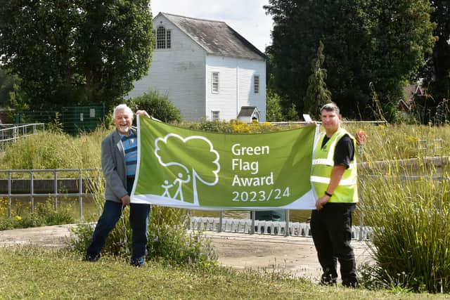 Councillor Chris Mullins and Patch Worker Steven Weston hold the Green Flag Award (Photo by Jon Rigby)