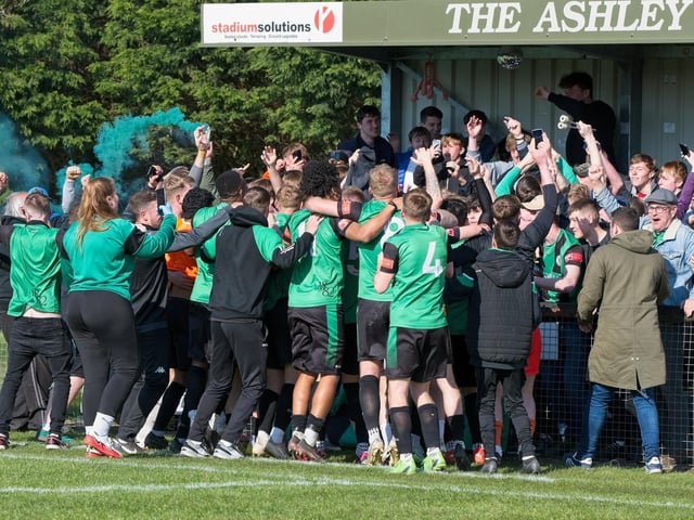 Burgess Hill Town players, fans and staff celebrate surviving in the Isthmian south east division at the end of their 0-0 draw with Beckenham