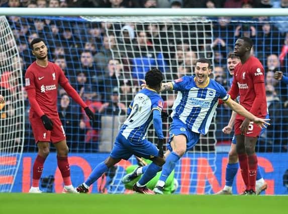 Brighton and Hove Albion skipper Lewis Dunk celebrates his goal with Tariq Lamptey against Liverpool