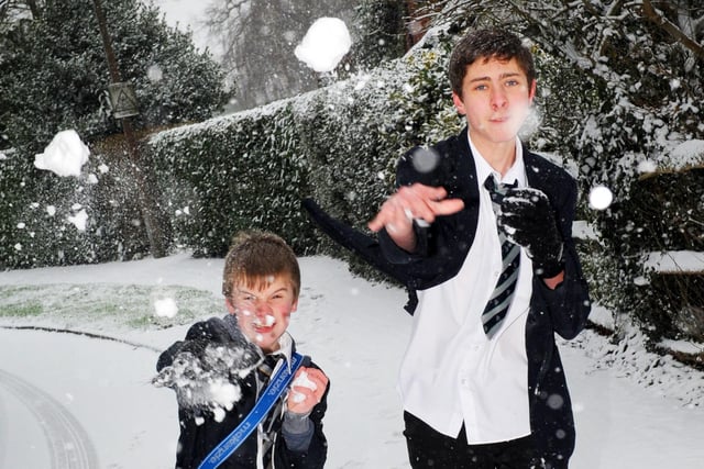 Two students throwing snowballs in Broadbridge Heath
