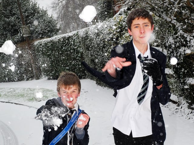 Two students throwing snowballs in Broadbridge Heath