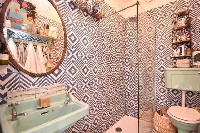 The bathroom has eye-catching geometric tiles