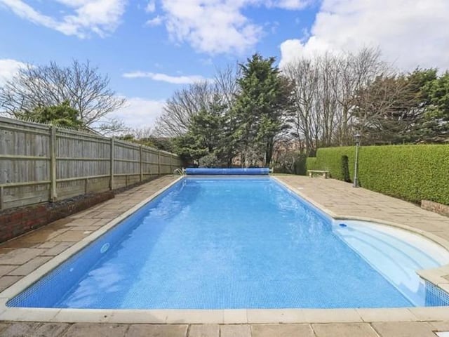The rear the patio is approximately 60ft in width and is a real sun trap. The gardens are split into several well maintained and thought-out areas, the main area is level being mainly laid to lawn, with steps leading down to the 40ft by 18ft swimming pool with paved seating area and covered pool boiler room. A private wooded area and wild garden is located at the foot of the garden.
